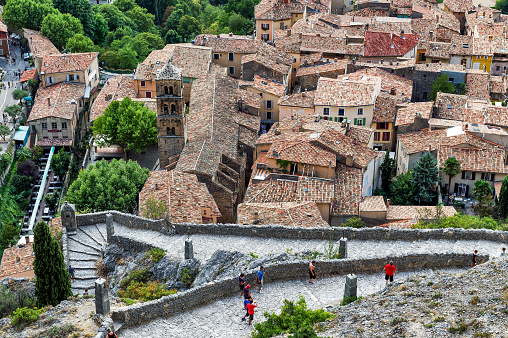 Europe, France, Alpes-de-Haute-Provence, Regional Natural Park of Verdon. Moustiers-Sainte-Marie, labeled The Most Beautiful Villages of France. View of the red roofs of the old village and the campanile