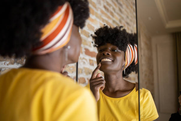 istock Handsome woman applying moisturizer to his face 1433212204