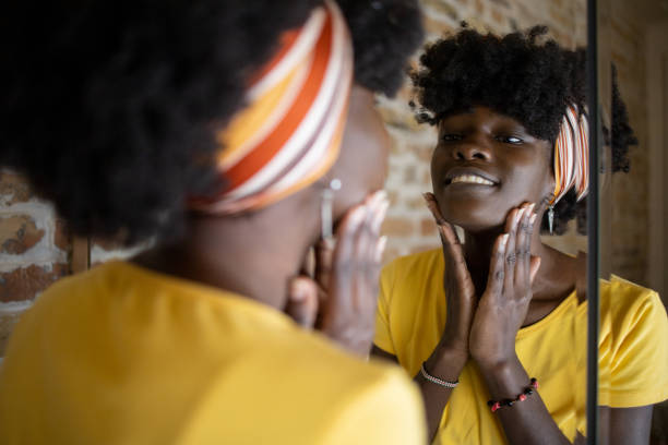istock Handsome woman applying moisturizer to his face 1433212248