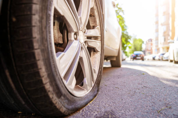 istock a flat car wheel. tire service. pump for car wheels. solar glare 1433212859