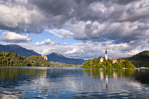 View of the picturesque Bled Lake with view of the church on the island. The area is a popular tourist destination offering a variety of outdoor activities for all ages.
