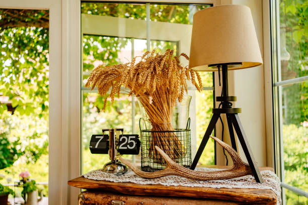 istock deer horn, retro clock, lamp and ears of wheat on the bedside table. 1433219722