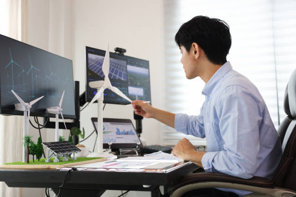istock Young smart design engineer design Green energy system , freelance engineer work at home office ,  engineer working on the wind turbines project 1433224623