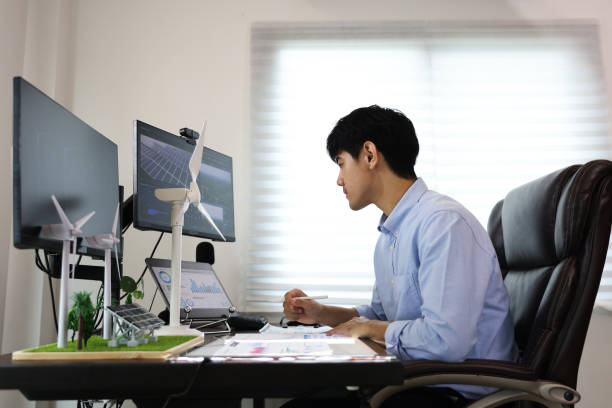 istock Young smart design engineer design Green energy system , freelance engineer work at home office ,  engineer working on the wind turbines project 1433224625