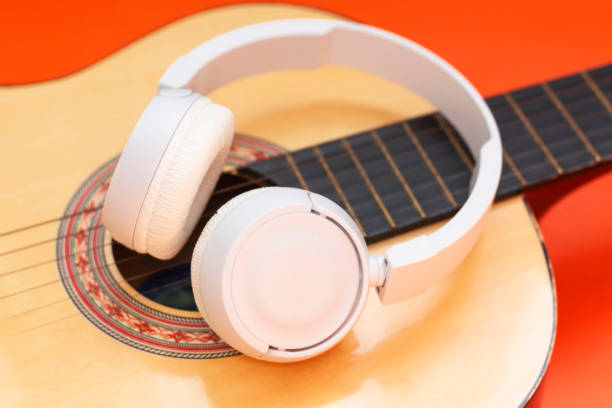 istock Wireless headphone on guitar. listen classical music 1433224652