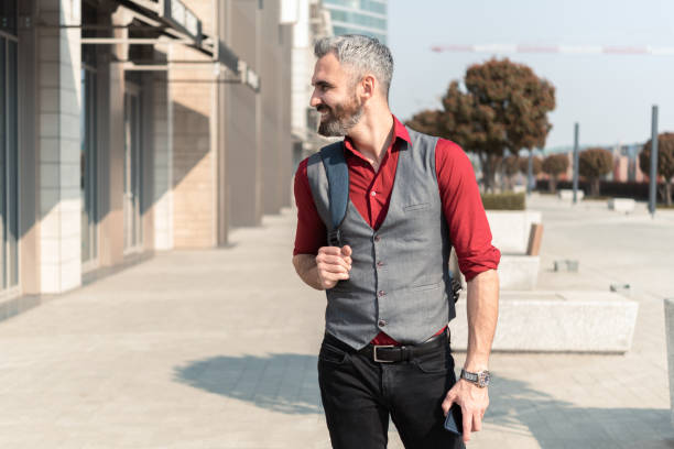 istock Handsome businessman walking to work and using smartphone 1433224779