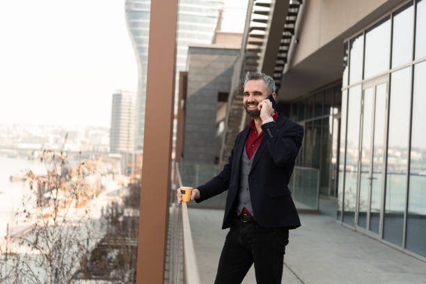 istock Handsome businessman on a coffee break making a phone call 1433224788