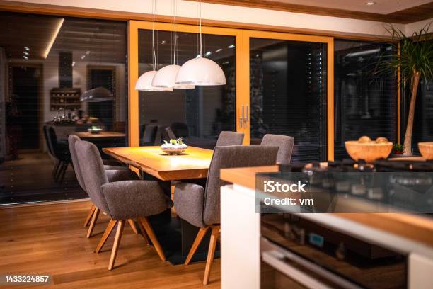 Kitchen With Table And Padded Design Chairs In Evening Stock Photo - Download Image Now