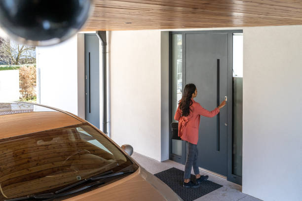 istock Long haired brunette unlocking modern house doors 1433224872