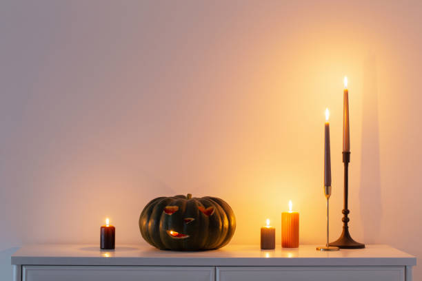 istock black halloween pumpkin with burning candles in white interior 1433225318