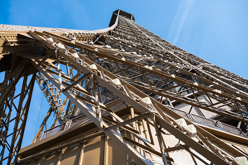 Eiffel tower close up. Angled view while climbing to the second froor of the landmark, selective focus