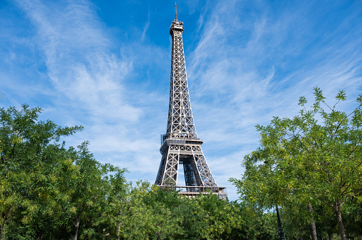 A view over the city of Paris, with the Eiffel Tower in the centre, and the modern office buildings of La Defense, the city's financial district, in the background.