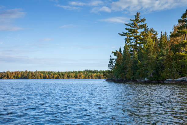 Blue lake in the Boundary Waters of northern Minnesota on a bright autumn morning Blue lake in the Boundary Waters of northern Minnesota on a bright autumn morning boundary waters canoe area stock pictures, royalty-free photos & images