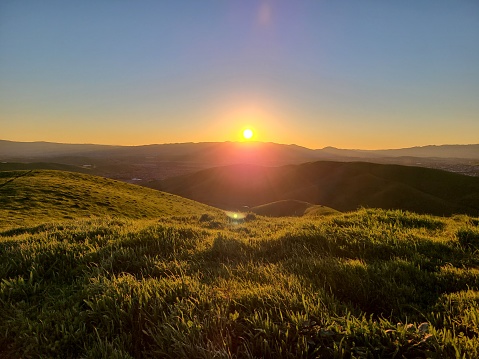 The sun sets behind the Las Trampas hills as seen from the hills to the east of the San Ramon Valley