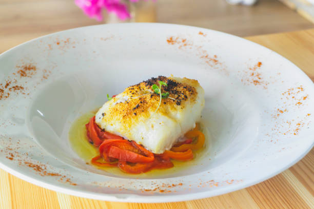 istock Delicious baked cod with roasted red pepper on wooden table. 1433232926