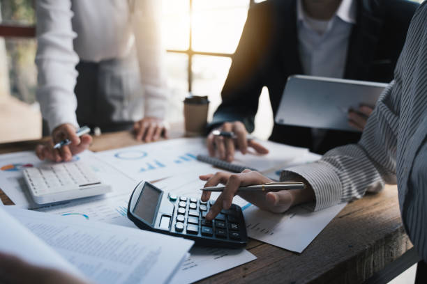 istock Business team meeting to discuss and summarize finance data, using calculator for calculate, pen, graph chart ,business people concept. 1433235412