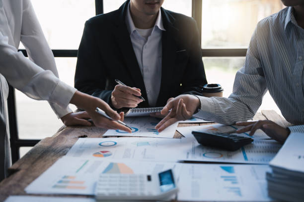 istock Business team    analyze using calculator to calculate and discuss the situation on the financial report in the meeting room, Business and Financial concept. 1433235444