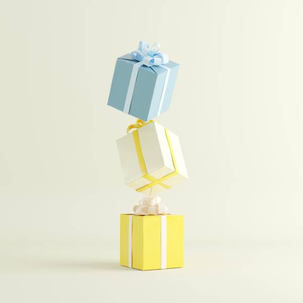 istock colorful yellow and blue gift box stacked on yellow background for copy space. 1433235475