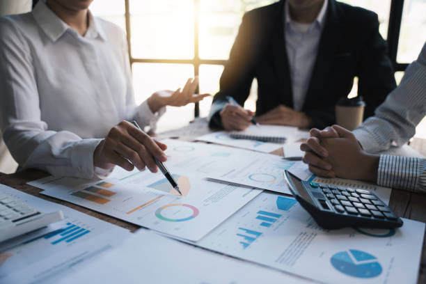 istock Business analyst checking in financial report and documents  donut chart, Accounting and Financial Concept. 1433235543