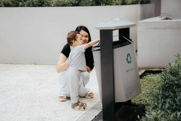 mother teaching her son how to recycle waste