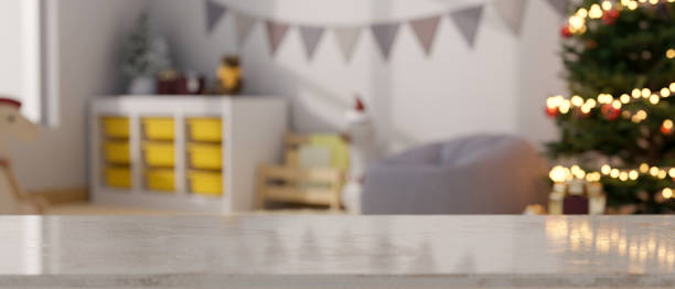 istock Empty mockup space on tabletop over blurred kid's playroom decorated in Christmas theme 1433251415