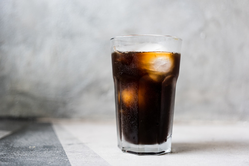 A glass of iced Americano or black coffee in coffee shop.