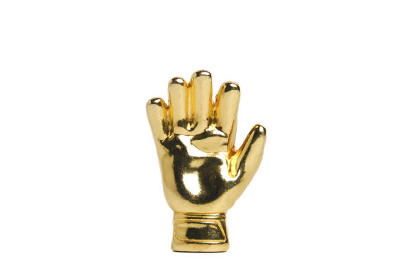 A picture of miniature golden gloves on white background. Award for Best Goalkeeper.