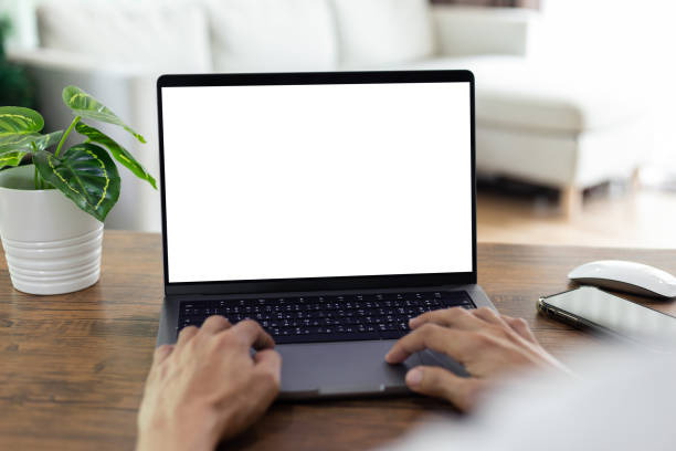 istock mock up businessman working empty screen computer on wood desk in home. Notebook Laptop with blank screen 1433263638