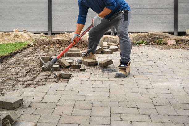 istock Man Loosening Pavers with Pick Mattock 1433263691