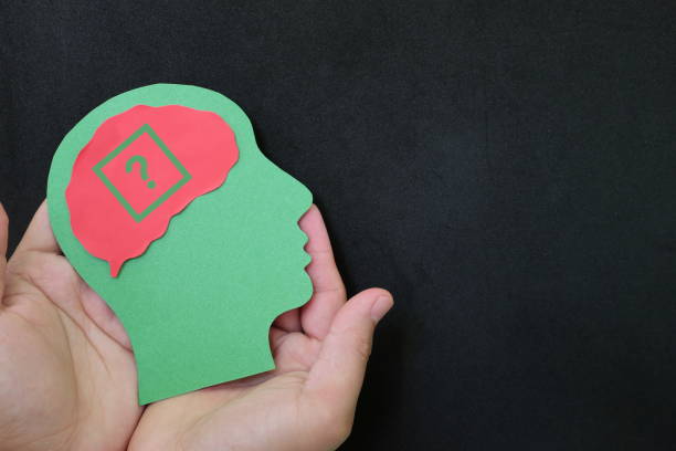 istock Human hands holding human head cutout with question mark in brain. Memory loss, uncertainty, dilemma, confusion and questioning care and support concept. 1433263739