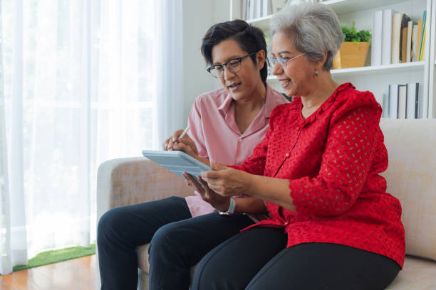istock Son teaches his mother how to use digital tablet. 1433266820
