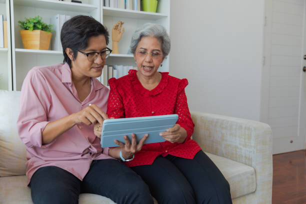 istock Son teaches his mother how to use digital tablet. 1433266837