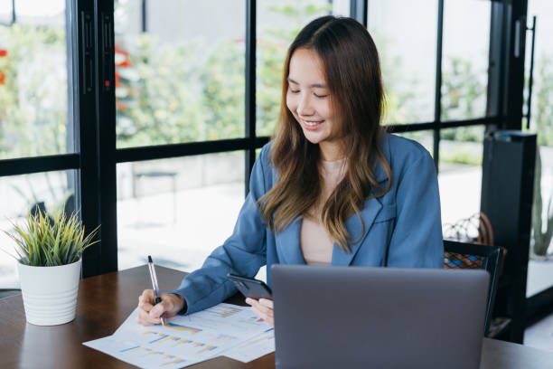 istock Freelance Freelancer asian woman smiling her working with laptop computer and smartphone for working job at workspace. small business with freedom lifestyle concept. 1433280831