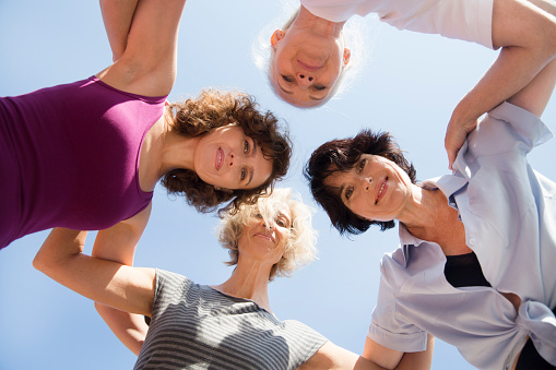 mixed age group women having fun together after yoga lesson outdoor. healthy lifestyle. diverse friendship