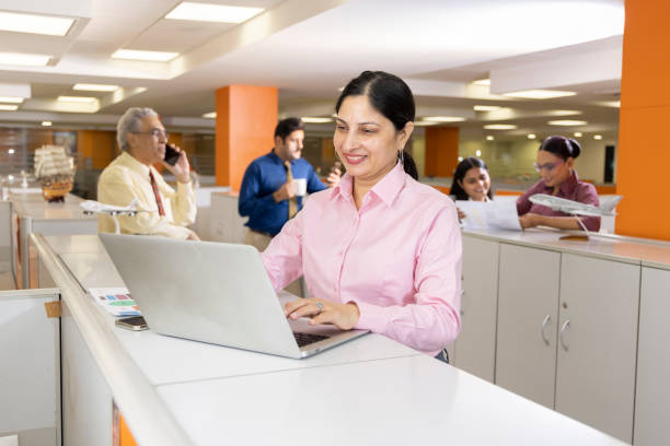 istock Happy businesswoman using laptop in office. 1433282789