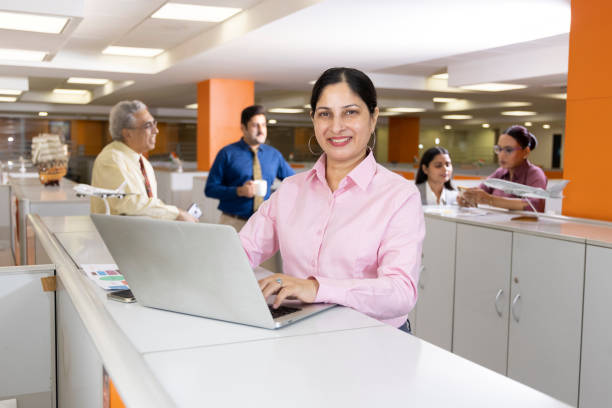 istock Happy businesswoman using laptop in office. 1433282856