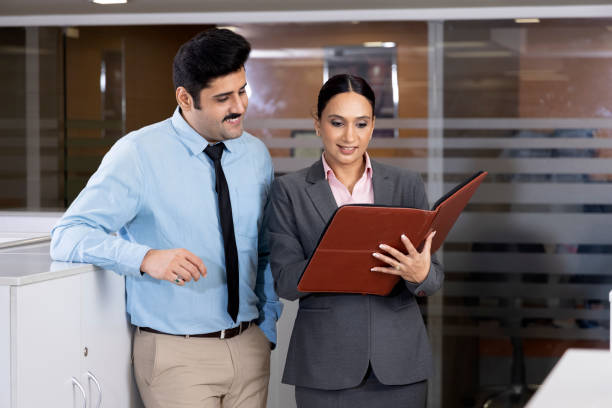 istock Businesswoman discussing over document with colleagues. 1433283871