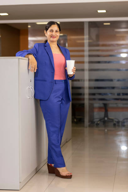 istock Businesswoman drinking coffee at office. 1433284219