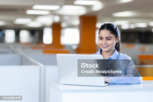 istock Happy businesswoman using laptop in office. 1433286328