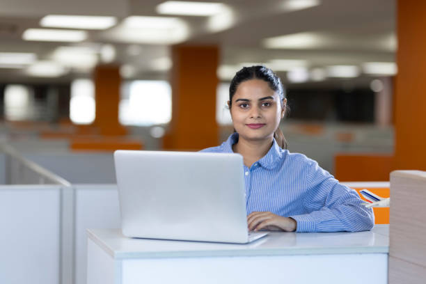 istock Happy businesswoman using laptop in office. 1433286355