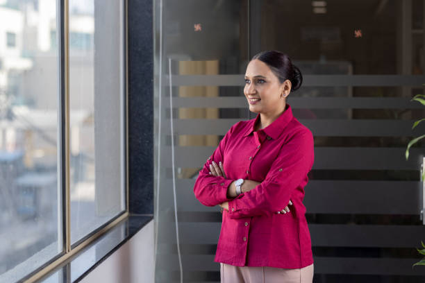 istock Smiling thoughtful businesswoman looking through window. 1433286482