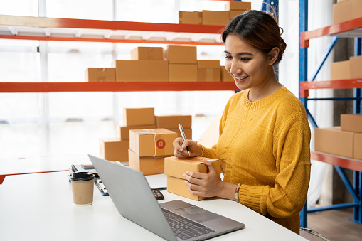 Starting small businesses SME owners female entrepreneurs check online orders to prepare to pack the boxes, sell to customers, sme business ideas online.