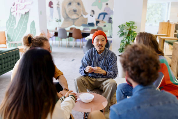 istock Group of cheerful colleagues playing charades 1433288440