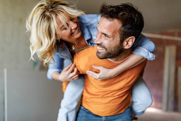istock Carefree couple having fun while piggybacking at construction site. 1433290612
