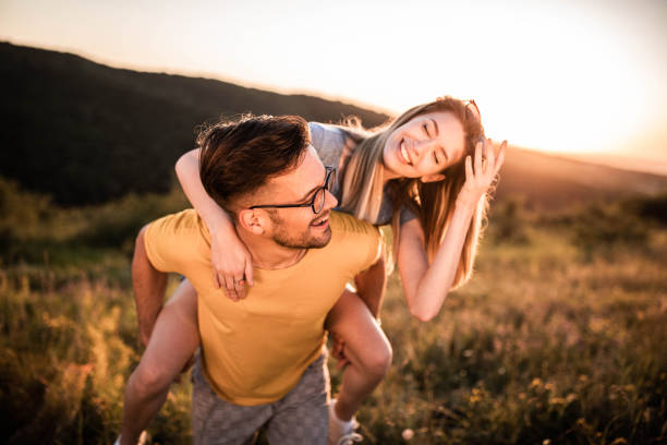 istock Playful couple having fun while piggybacking in springtime. 1433291977