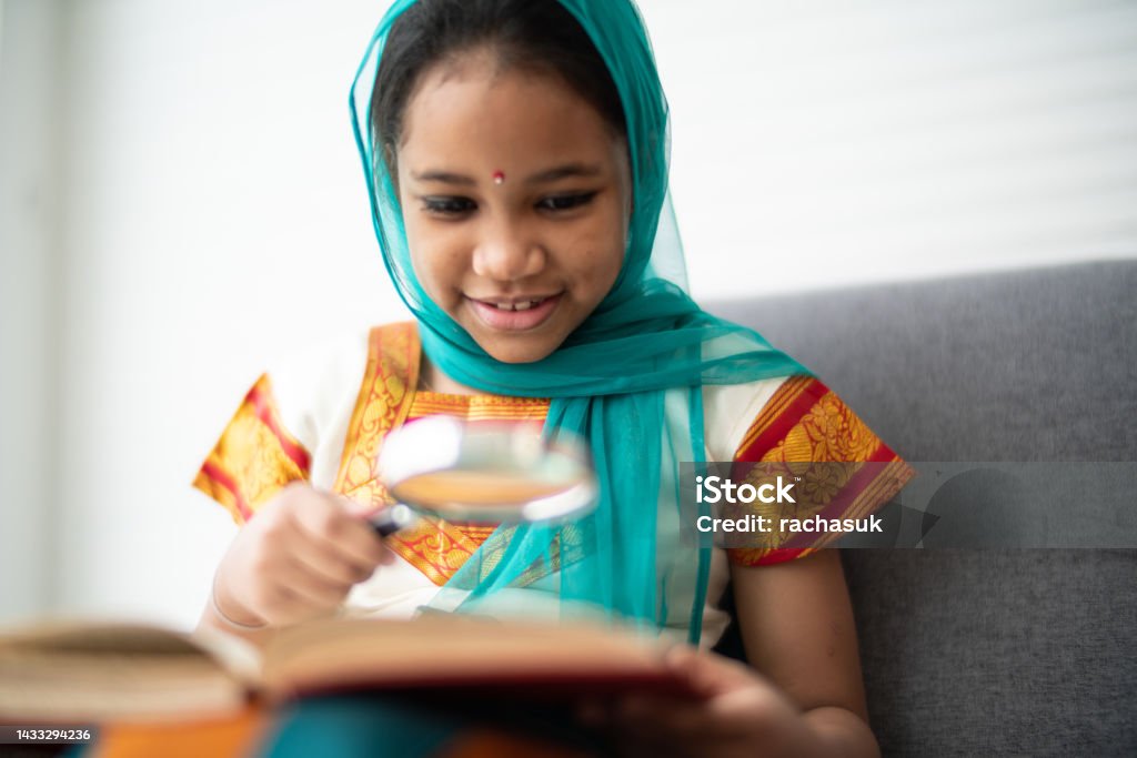 Young indian girl reading a book Child Stock Photo