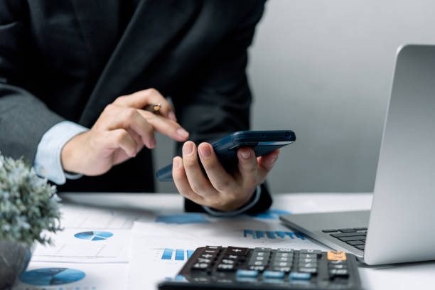 istock Businessman using smartphone marketing laptop computer business network manager. man using notebook internet online technology communication. 1433295334