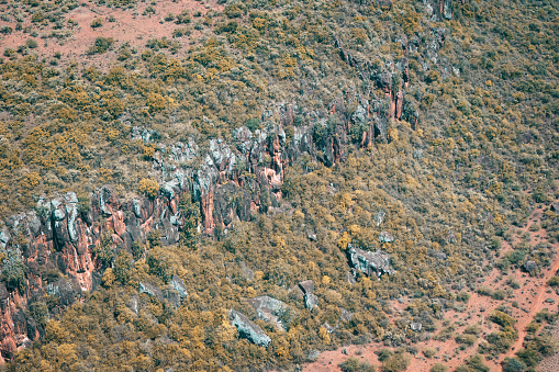 Somewhere in the land of the Masai, Kenya - March 24th 2022. Aerial view of a cliff and rock formation far away from civilization. No people visible, unfortunately no baboons either.