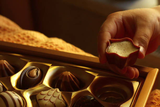 istock the child takes chocolates from a gift box 1433305126