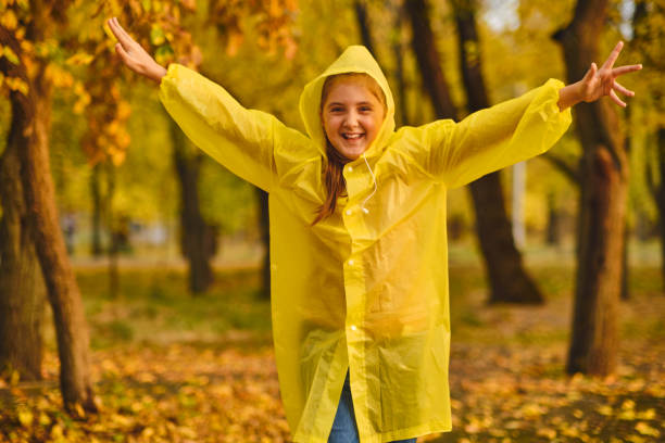 istock kid playing on the nature outdoors in autumn rain 1433306289